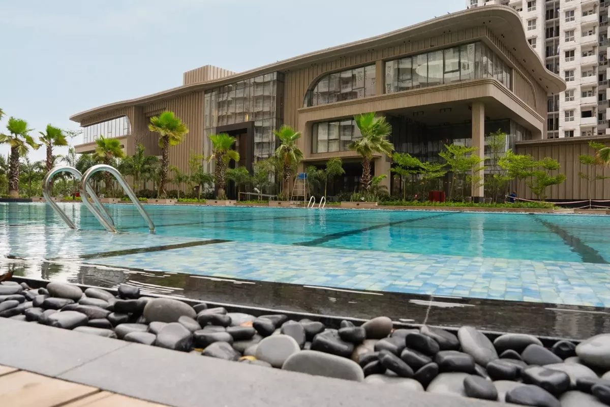 Club Mocha clubhouse exterior at dusk with illuminated facade and adjoining swimming pool